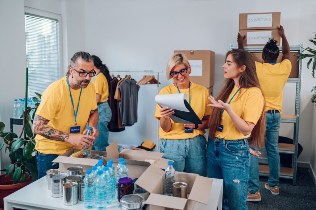 Group of multiracial volunteers working in community charity donation center